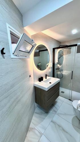 a bathroom with a sink and a mirror at Las Americas 200 B apartment in Costa de Adeje