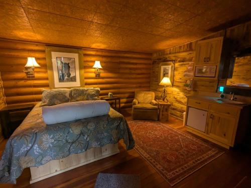 a bedroom with a bed in a log cabin at Laughing Horse Lodge in Bigfork