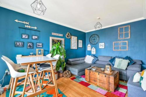 a blue living room with a couch and a table at 2-Bedroom Flat in Woking Walk to Station in Hurley