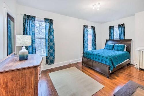 a bedroom with a bed and a table with a lamp at Roomy Lancaster Home Walk to Dtwn and Hospital in Lancaster