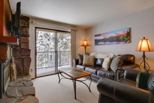 a living room with a couch and a fireplace at Winter Park Condo with Hot Tubs, 4 Mi to Ski Resort! in Winter Park