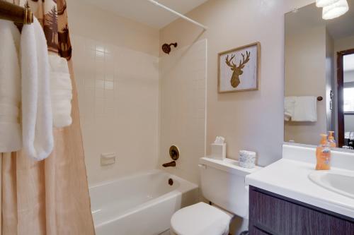 a bathroom with a tub and a sink and a toilet at Winter Park Condo with Hot Tubs, 4 Mi to Ski Resort! in Winter Park