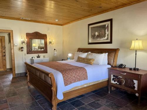a bedroom with a large bed and a wooden ceiling at Lajitas Golf Resort in Terlingua