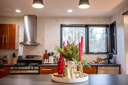 a kitchen with a table with christmas decorations on it at Forest Green Retreat in Brattleboro