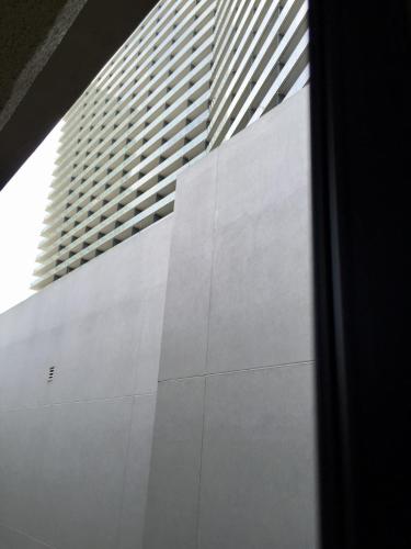 a white building with a tall building in the background at Jockey Resort Suites Center Strip in Las Vegas