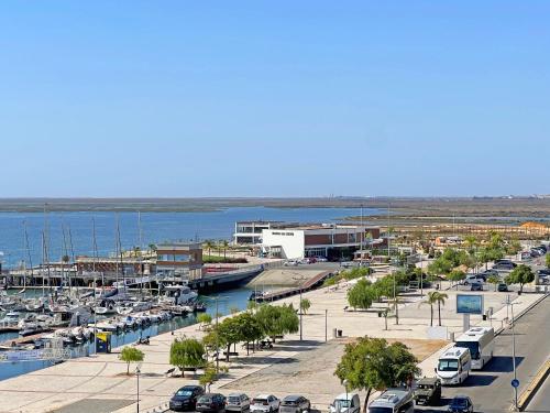 a marina with cars parked in a parking lot at Lady Delmar Marina Olhao By Junto ao Mar in Olhão