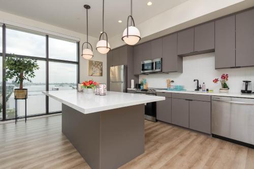 a kitchen with a large white counter top and large windows at Spacious 3Bedroom Apt close to LAX & Sofi Stadium* in Los Angeles