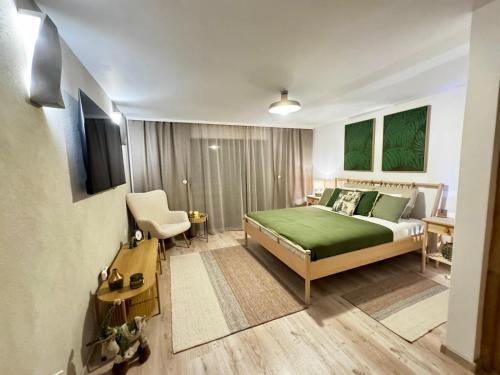 a bedroom with a bed with a green bedspread at UMANI Retreat 2 in Buşteni
