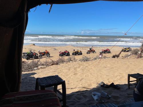 a group of people riding motorcycles on the beach at The Bay House Essaouira in Essaouira
