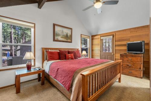a bedroom with a large bed and a tv at Leisure Lane 4 in Sunriver
