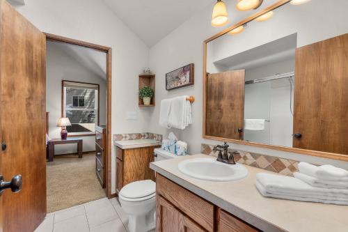 a bathroom with a sink and a toilet and a mirror at Leisure Lane 4 in Sunriver
