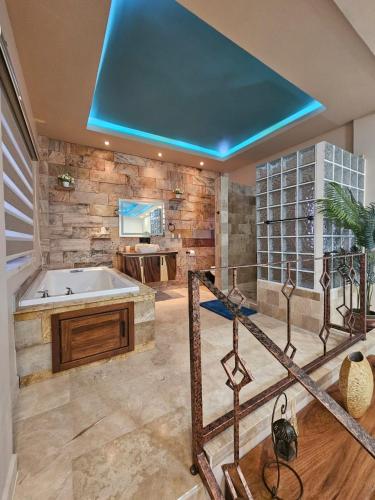 a large bathroom with a tub and a sink at Casa Flor del Desierto in Loreto