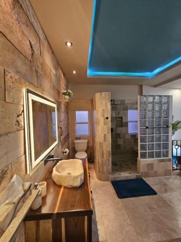 a large bathroom with a sink and a shower at Casa Flor del Desierto in Loreto