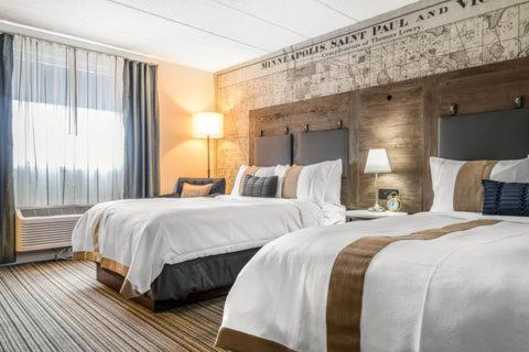 a hotel room with two beds and a window at enVision Hotel Worcester Downtown in Worcester