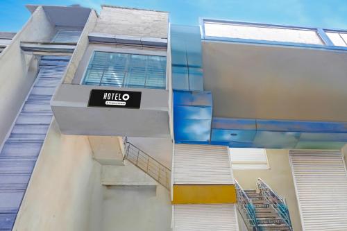 a building with a sign on the side of it at Hotel O Sector 110 Noida Formerly Luv Kush Tower Bhangel in Noida