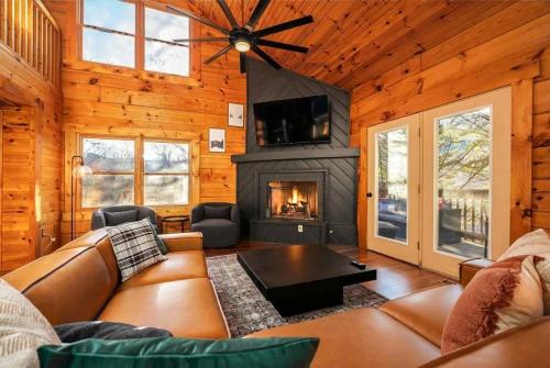 Una sala de estar con un sofá y una chimenea. en Movie Theater Arcade Hot Tub Grill Views, en McGaheysville