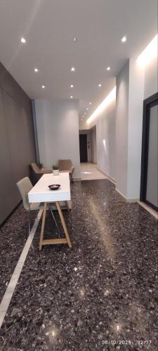 a room with a white table and chairs in it at Ptolemeon 20, Apts & Studios Thessaloniki Center in Thessaloniki