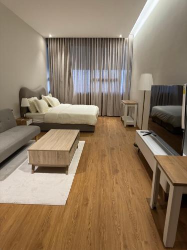 a living room with two beds and a coffee table at سكينة هاوس in Riyadh