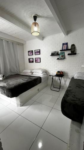a bedroom with a bed and a table in it at Casa do Point in Saquarema