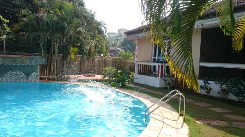 a swimming pool in front of a house at Justin Apartment in Varca