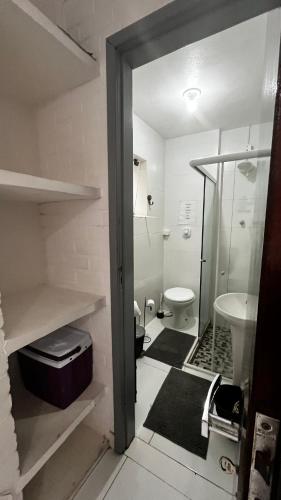 a bathroom with a toilet and a sink at Casa do Point in Saquarema