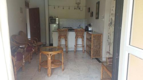 a kitchen with chairs and a table and a counter at Justin Apartment in Varca