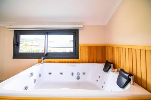 a bath tub in a room with a window at Villa Unique 2 in Fethiye