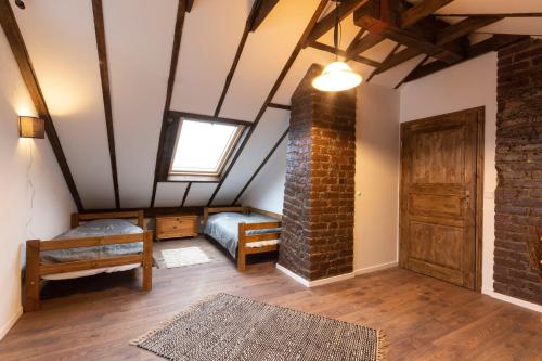 a attic room with a brick pillar and a window at Haus-Elena in Bestwig