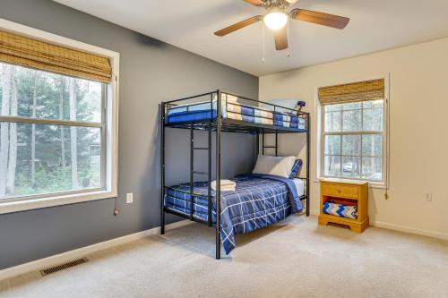a bedroom with a bunk bed and two windows at Fire Pit, Games and Outdoor Fun! Poconos Retreat in Blakeslee