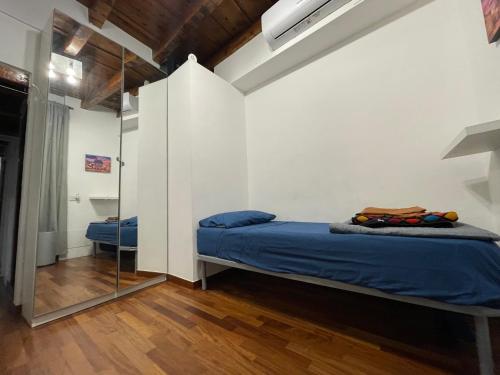a bedroom with a bed and a mirror at La Casa di Alissia a Brescia in Brescia