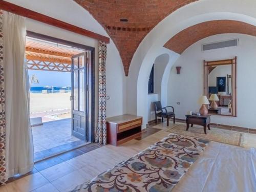 a living room with an open door to the beach at Beach safari suites &expedition in Marsa Alam City