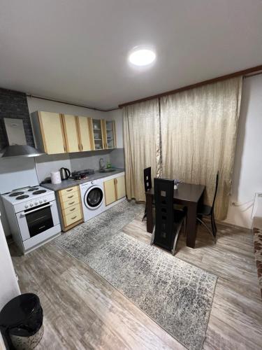 a small kitchen with a table and a stove at Adi apartment in Sarajevo