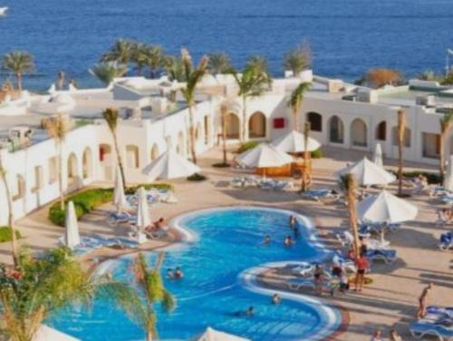 a resort with a swimming pool next to the ocean at Beach safari suites &expedition in Marsa Alam City