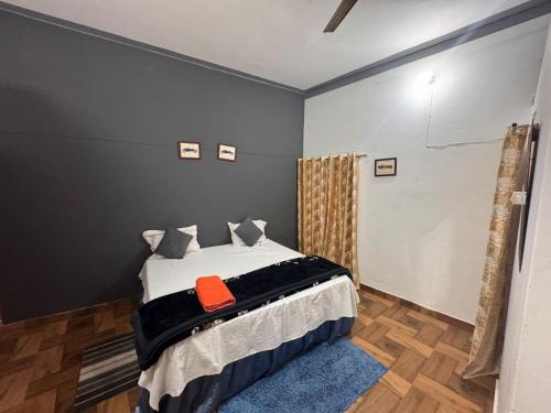 a bedroom with a bed with a red pillow on it at AP Homestay in Faizābād