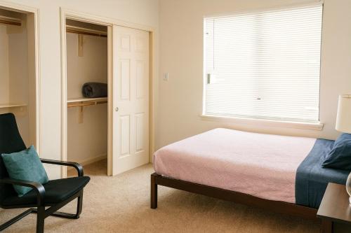 a bedroom with a bed and a chair and a window at Affordable Central Houston Stay Minutes from Downtown No Smoking in Houston
