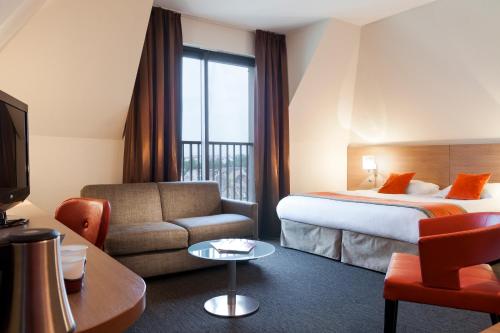 Postel nebo postele na pokoji v ubytování Kyriad Hotel Strasbourg Lingolsheim
