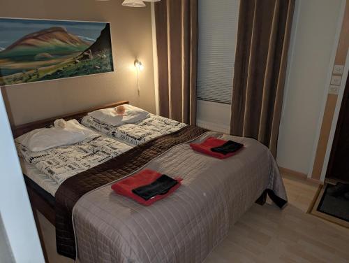 a bedroom with a bed with two towels on it at Arctic Red House in Rovaniemi