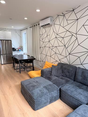 a living room with a couch and a table at The View - Direct Bus Time Square NYC Breakfast Included - B in Jersey City