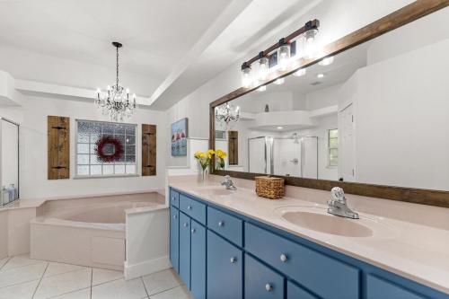 a bathroom with two sinks and a large mirror at Citrus Springs Oasis-Rainbow River, Manatees, Golf in Citrus Springs