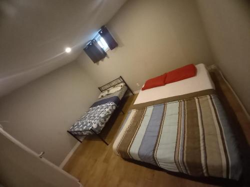 a small room with two beds and a window at Central Location New Year Stay- Free Parking & Fast Wifi in Kitchener