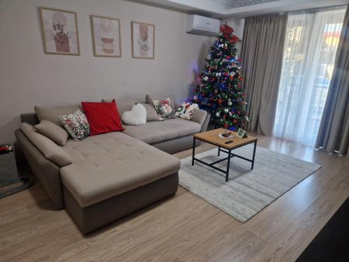 a living room with a christmas tree and a couch at WRW Airport Residence in Otopeni