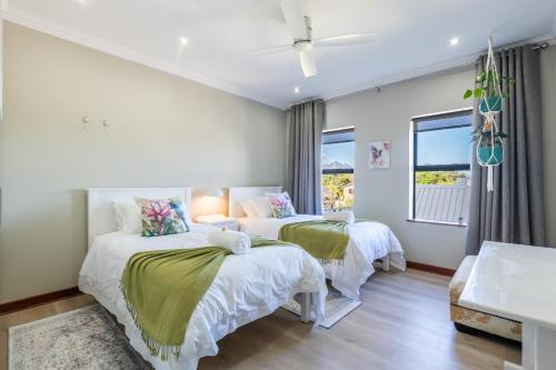 a bedroom with two beds and a window at Amara Mountain View George in George