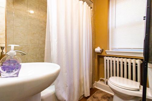 a bathroom with a white shower curtain and a toilet at FIFA 2026 Hub - Philadelphia Area in Bryn Mawr