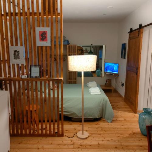 a bedroom with a bed and a lamp in it at Umbria Valnerina , Il TARTUFFO, sulla via di Francesco in Scheggino