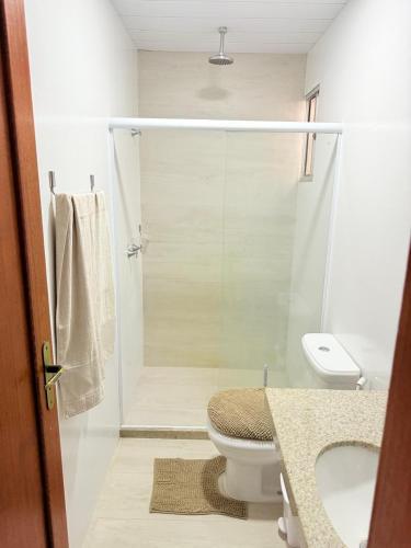 a bathroom with a shower with a toilet and a sink at Sossego Ponta da Fruta in Vila Velha