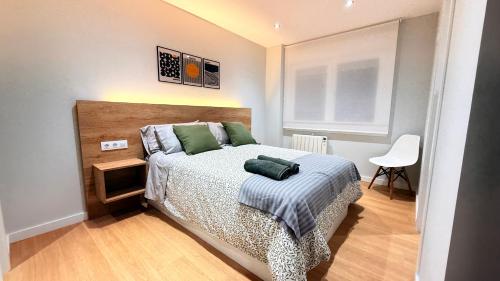 a bedroom with a bed and a table and a chair at Fogar de Breogan in A Coruña