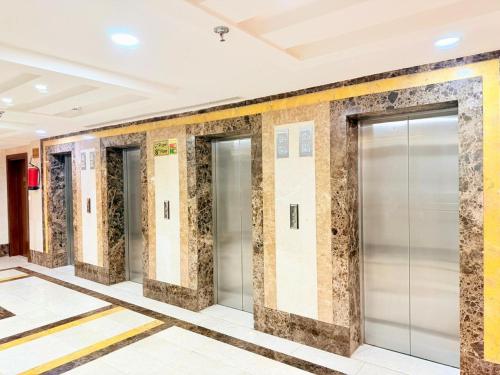 a row of elevator doors in a building at Mizab Hotel From Nebras Alhuda in An Naqāʼ