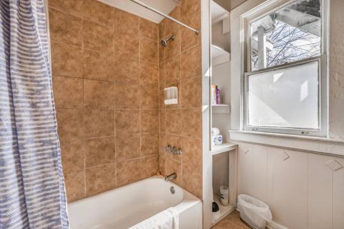a bathroom with a bath tub and a window at The Clearview Hideaway - Cozy in Memphis