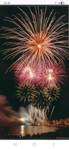 a group of fireworks exploding in the sky over the water at Casa junto al mar in Blanes