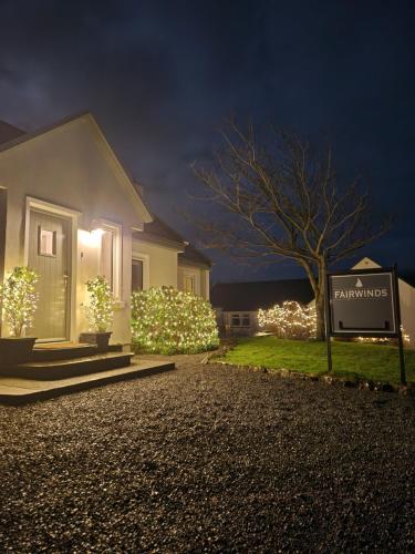 a house with christmas lights in the yard at Fairwinds Guest Accommodation in Doolin